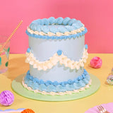 Vintage Cake - Tonal Colour with blue and white Swiss Meringue icing, six layers, and decorative piped details by Crumbs & Doilies